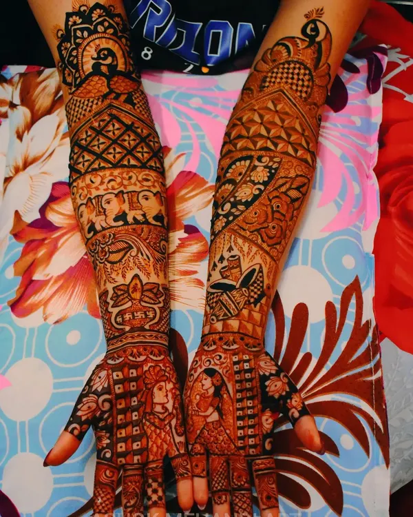 This full-arm bridal mehndi is a perfect example of how I weave a couple's story into the design. It features detailed portraits of the bride and groom, surrounded by traditional motifs like elephants and peacocks, creating a complete narrative.