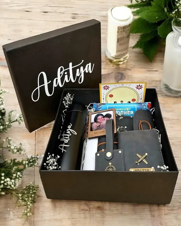 A thoughtfully curated gift box for 'Aditya', featuring a personalized tumbler, wallet, and keychain, along with a cherished photo to make it extra special.