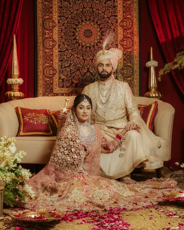 A portrait of royalty. This shot of Aashna and Akshay, posed against a lavish, regal backdrop, captures the grandeur and timelessness of a classic Indian wedding.