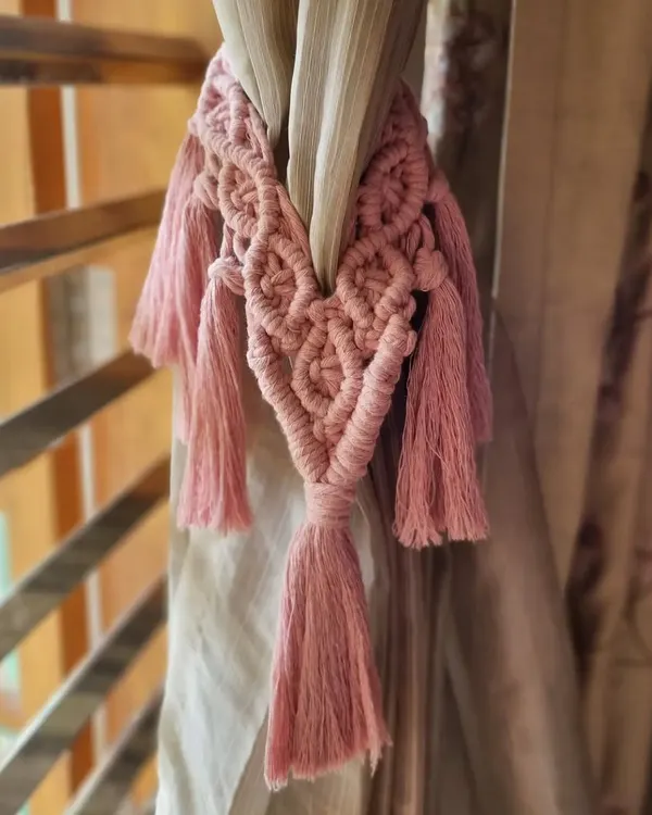 Transform your space with our handcrafted macrame curtain ties. This pink tie-back adds a touch of soft, boho chic to your window treatments.