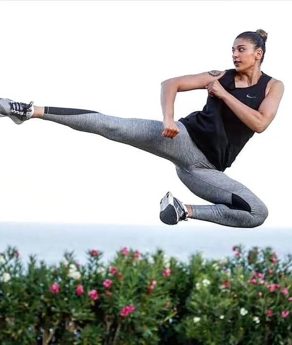 A powerful flying side kick, demonstrating the explosive strength and agility we develop in our kickboxing and taekwondo sessions. This is about learning what your body is capable of.