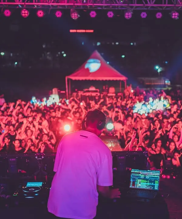 This is my view from the stage, commanding the energy of a massive crowd. I live for moments like this, connecting with thousands of people through music and creating an unforgettable festival atmosphere.