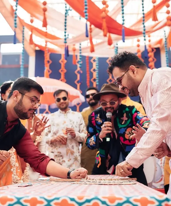 A high-stakes card game between the bride and groom's side at a Haldi in Jaipur. The competitive spirit and laughter make these games a highlight of the wedding.