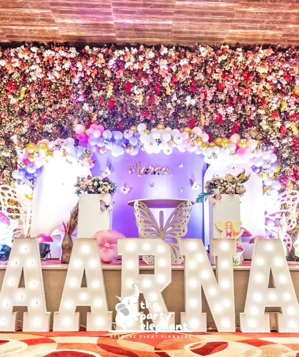 We created a spectacular butterfly fairyland for a first birthday, transforming the venue into an enchanted garden. This grand setup features a massive floral arch, custom marquee letters, and whimsical fairy and butterfly details to make the celebration truly magical.
