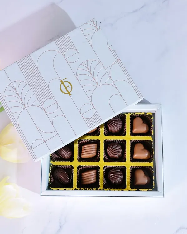 Indulgence, beautifully boxed. Our 12-piece praline collection features a variety of handcrafted chocolates, perfect for gifting or as a personal treat.