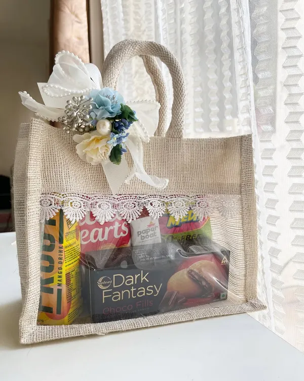 Make your destination wedding guests feel welcome the moment they arrive. This custom jute welcome bag is filled with snacks, drinks, and essentials, all beautifully presented with lace detailing and a floral touch to match your wedding theme.