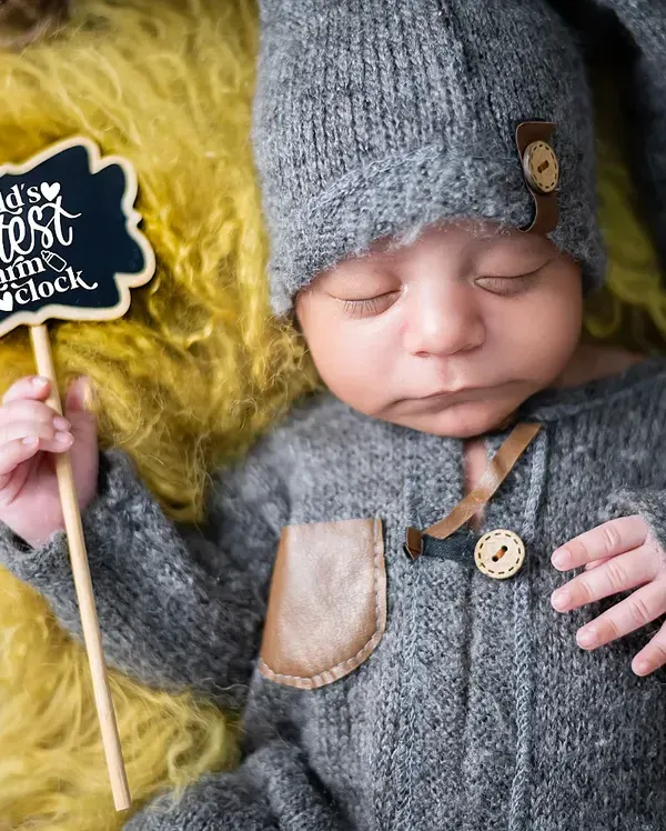 We think this little sign says it all. This newborn portrait, with the baby in a cozy knit outfit, highlights the cute and funny details we love to include in our sessions.