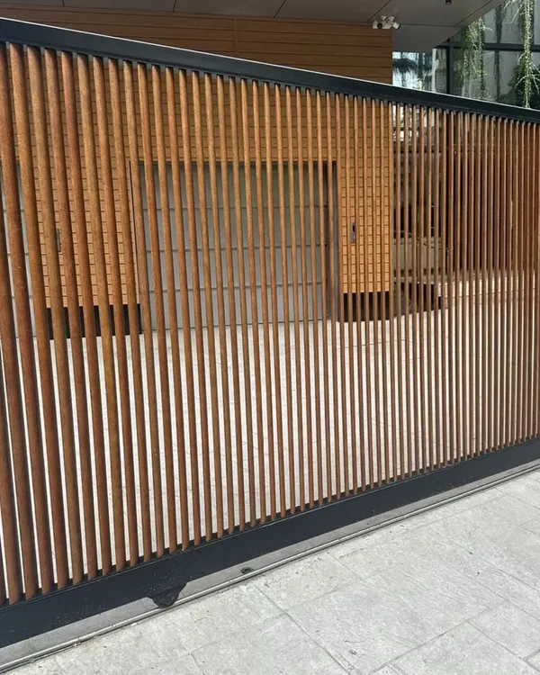 Your main gate is the first impression of your home. This custom sliding gate uses our durable, low-maintenance Tipwood in a vertical slat design, blending security with modern aesthetics.