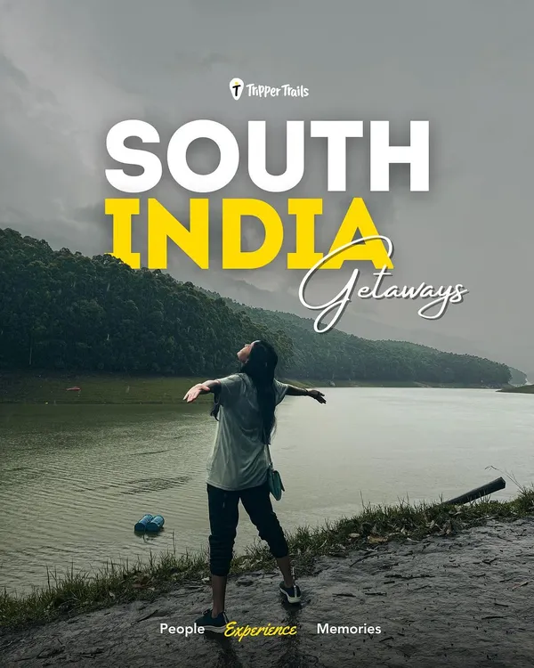 A woman stands with her arms wide open, overlooking a serene lake in the South Indian hills. This is the feeling of freedom and peace you get on my getaways.