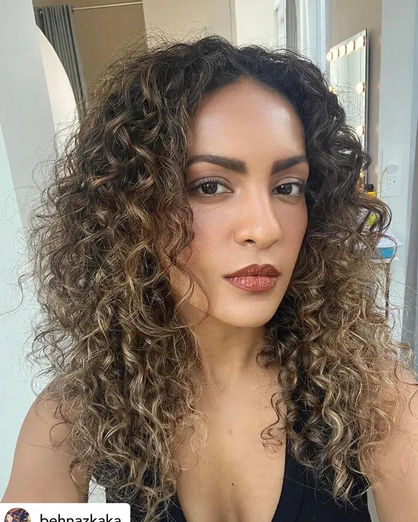 I love bringing curls to life with color. For this look, I hand-painted caramel blonde highlights to define each curl, creating dimension and shine while keeping the hair healthy and bouncy with a K18 treatment.