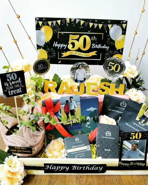 Marking a 50th birthday calls for something special. This elegant black and gold themed hamper includes a live plant, premium snacks, and is personalized with the recipient's name and photos to honor their big day.