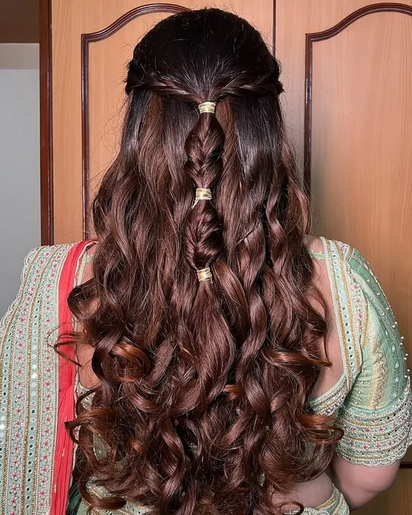 A detailed look at this beautiful braided hairstyle. The soft curls are woven into an intricate braid, creating a look that is both romantic and elegant.