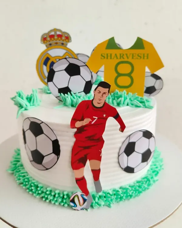 A cake for a true Cristiano Ronaldo fan! This CR7 themed cake features the football star, soccer balls, and a jersey with the birthday boy's name and age.