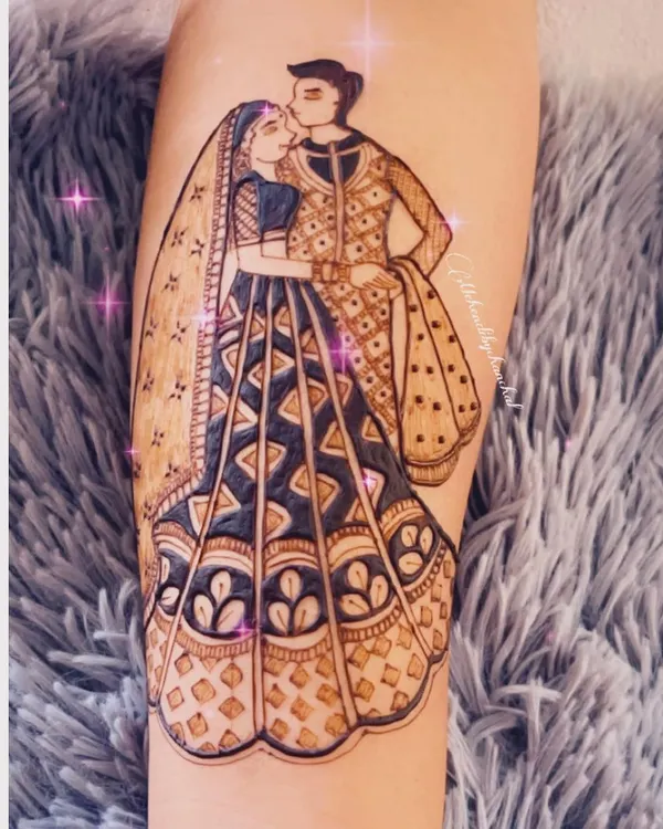 A romantic portrait of the bride and groom, capturing a sweet moment. This full-figure design on the forearm is a centerpiece of the bridal mehendi.