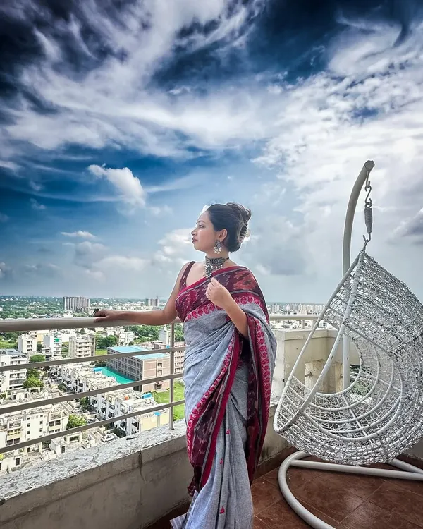 A dramatic shot of my grey and maroon Ikat saree against a cloudy sky. Handloom fabrics like Ikat have a rich texture and story that makes any look feel special.