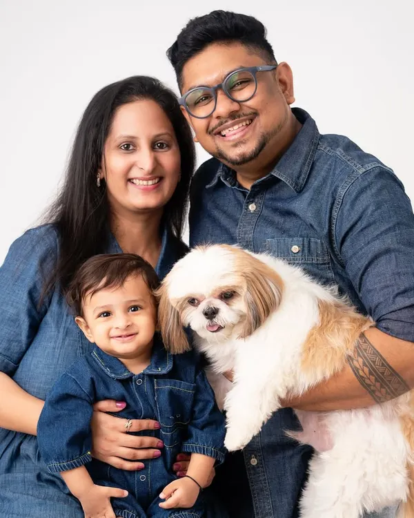 The perfect family portrait includes everyone, even the furry members. This beautiful family, with their one-year-old and their adorable Shih Tzu, is a great example of the love I aim to capture.