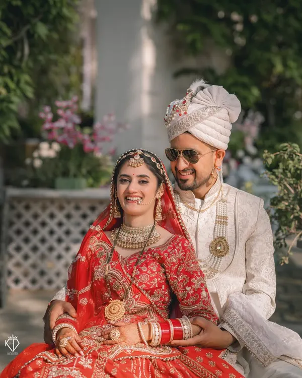 A joyful, candid moment between the bride and groom during their wedding portraits at the beautiful Woodville Palace in Shimla.