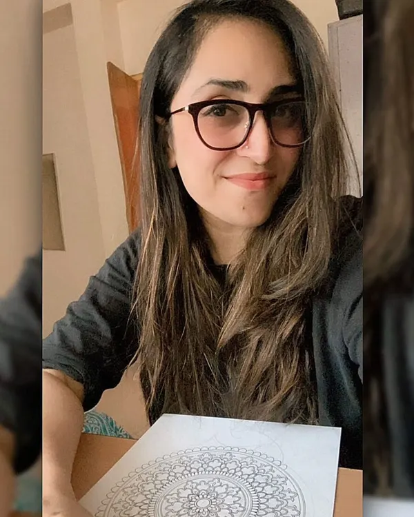 Hey, I'm Bhagyashree! This is me with one of my classic black and white mandalas. I'm the face behind all the art you see here, and I'm so happy to share my creative journey with you.