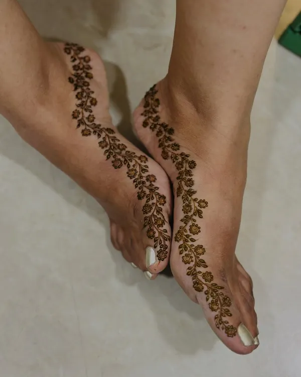 For the minimalist bride, a simple yet stunning floral vine that gracefully trails along the side of the foot. It's delicate, elegant, and timeless.