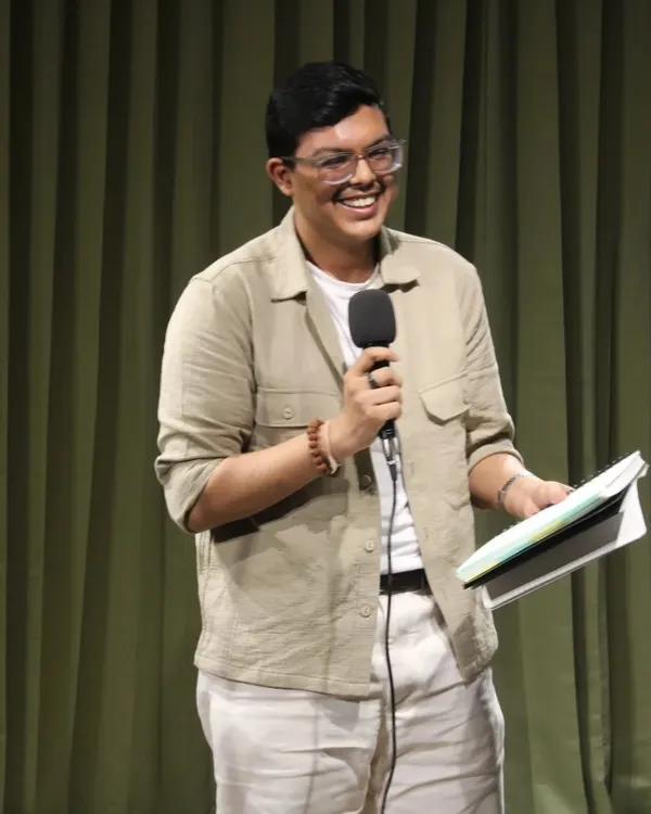 That smile says it all! A performer lights up the stage during "The Bean Grill" open mic, sharing their passion with an appreciative audience. Our space is perfect for these intimate performance events.