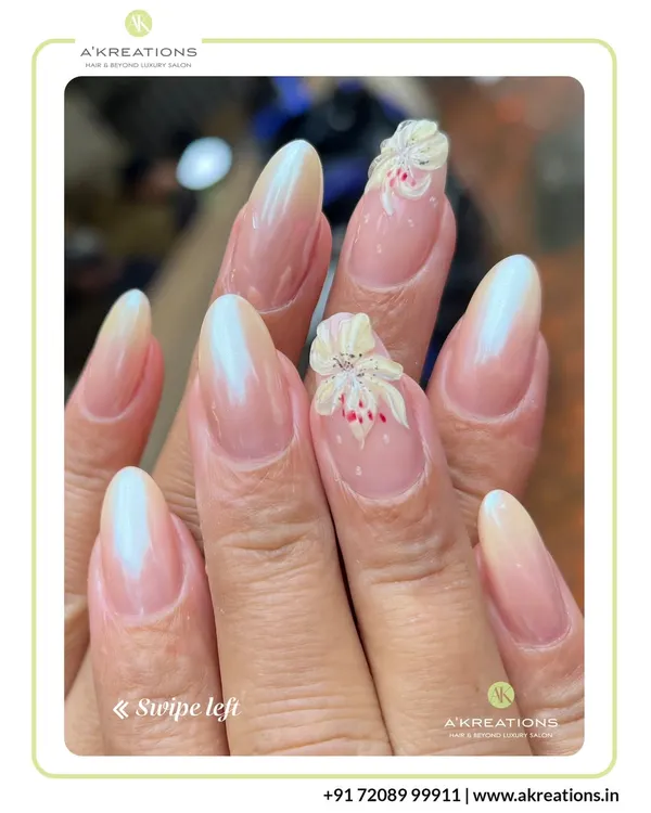 A subtle and elegant design featuring an ombre French manicure on almond-shaped nails, accented with a delicate, hand-sculpted 3D white flower.