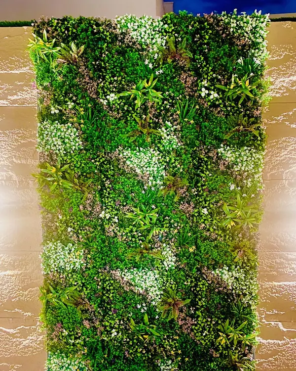 This is one of our most popular premium designs, featuring a dense mix of ferns, succulents, and flowering sprigs. The variety of textures and shades of green creates a highly realistic and lush indoor feature wall.