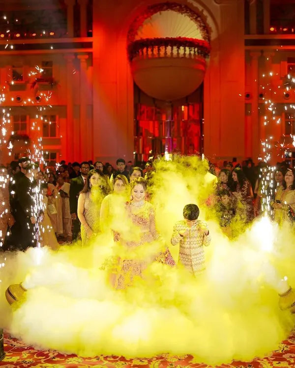 A spectacular groom's entry, complete with colored smoke and cold pyro, creating a dramatic and unforgettable start to the wedding ceremony. We are equipped to capture these grand moments perfectly.