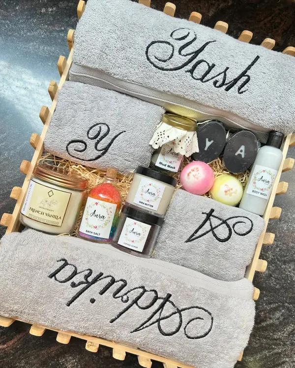 This is my signature wedding hamper, and it’s my absolute favorite to create. It features a complete spa set for the happy couple, including soft grey towels embroidered with their names and initials, my homemade charcoal soaps, bath bombs, a French vanilla candle, and more.