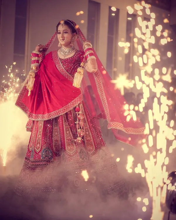 A bride's grand entrance is a once-in-a-lifetime moment. We use dramatic lighting and effects like these sparklers to create a truly cinematic and breathtaking memory that feels straight out of a movie.