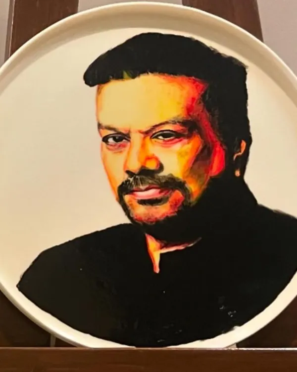 A portrait of celebrity journalist Vir Sanghvi, painted with ceramic paints on a bone china porcelain plate. This was a unique commission for ITC Gardenia that required a completely different technique from painting on canvas.