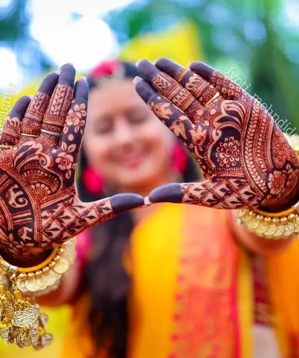This is the moment it all comes together. I love capturing the joy of a bride seeing her complete mehndi, a beautiful frame for her happy memories. This design features traditional motifs with a rich, dark stain from my organic henna.