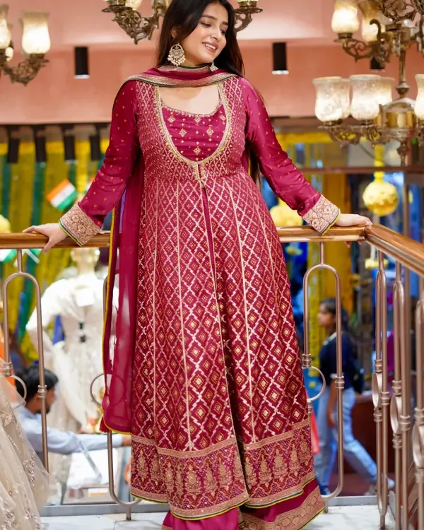 Own the spotlight in this stunning magenta Anarkali suit. The rich brocade fabric and flattering silhouette make it a perfect choice for any festive occasion.