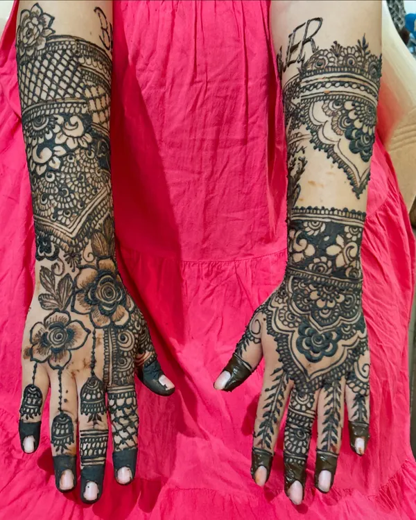 This is a perfect example of my passion for detailed work. I created two completely different, intricate designs for each hand, blending traditional Indian patterns with modern floral elements for a truly unique party look.