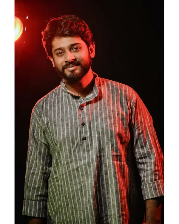 A smiling portrait from a studio session in a striped kurta. This demonstrates my ability to convey a warm and positive expression under directed lighting, suitable for lookbooks and brand catalogues.