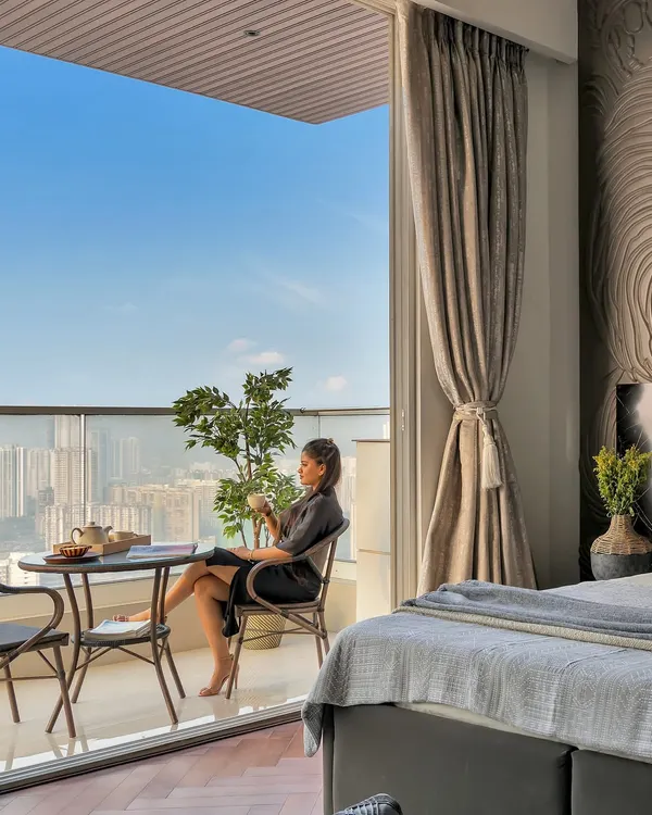 This is what I mean by a 'staycation state of mind'. A bedroom shouldn't just be for sleeping; it should be a personal retreat. Here, the boundary between inside and out dissolves, creating a serene space to sip your morning tea while overlooking the city skyline.