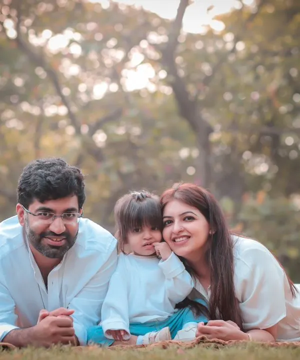A family portrait taken while lying on the grass in a park. This is the essence of our relaxed, fun outdoor sessions.