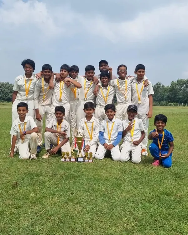 Our victorious U12 cricket team posing with their medals and trophies after being crowned champions at the CBT tournament. A proud moment for the players, coaches, and parents.