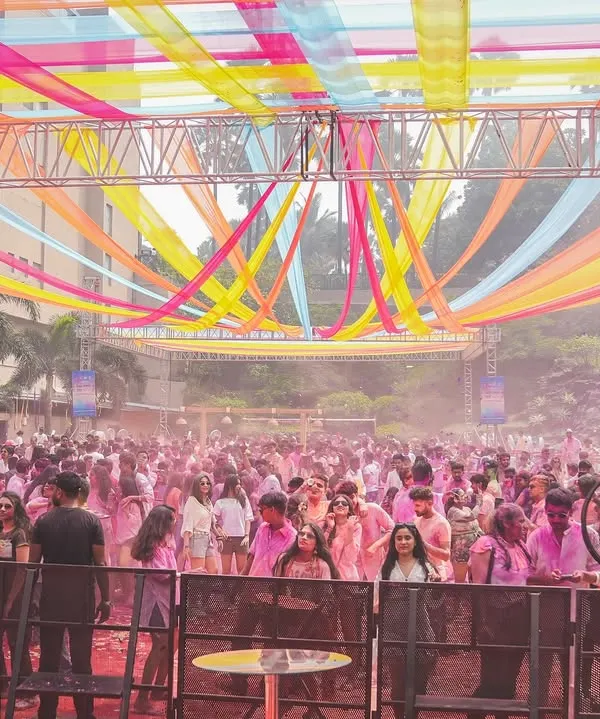 The setup for a massive Holi 2025 party. The colorful streamers and huge crowd show the scale of the event, and I was ready to bring the energy.