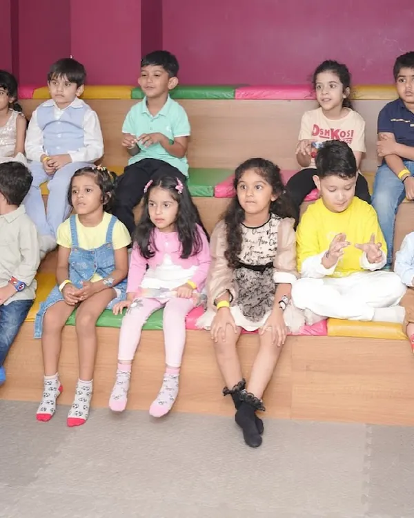 A group of young guests sitting in our tiered seating area, watching a magic show or movie screening.