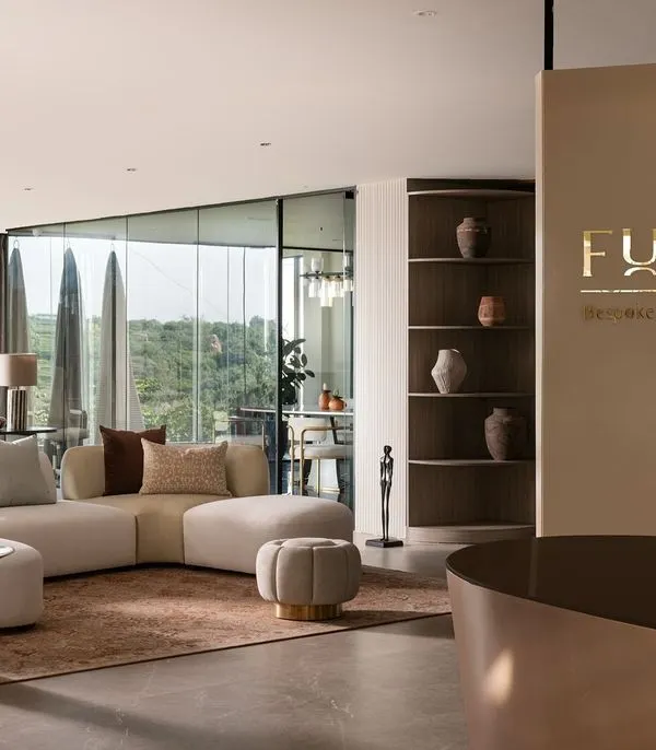 Welcome to the Furbishy Experience Center in Hyderabad. This space, which we built from a bare concrete shell, is the heart of my design philosophy. It combines luxurious, custom-made furniture and a serene color palette with breathtaking views of KBR National Park, showcasing how I blend sophisticated design with the surrounding environment.