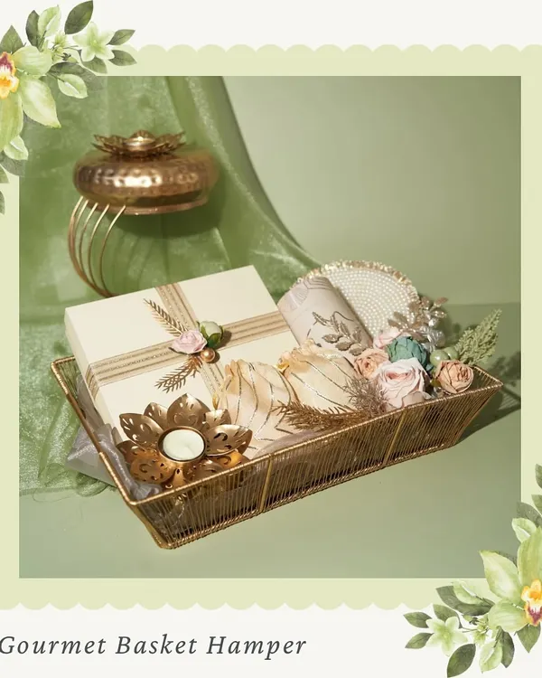 Our Gourmet Basket Hamper for Diwali. This beautifully arranged basket includes boxes of mithai, chocolates, and a decorative diya, all presented in an elegant gold wire basket.