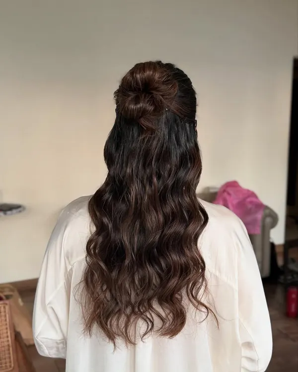 A clear view of this half-up glam hairstyle. I created a small top knot and let the rest of the hair flow in mesmerizing waves, a perfect look for any party.