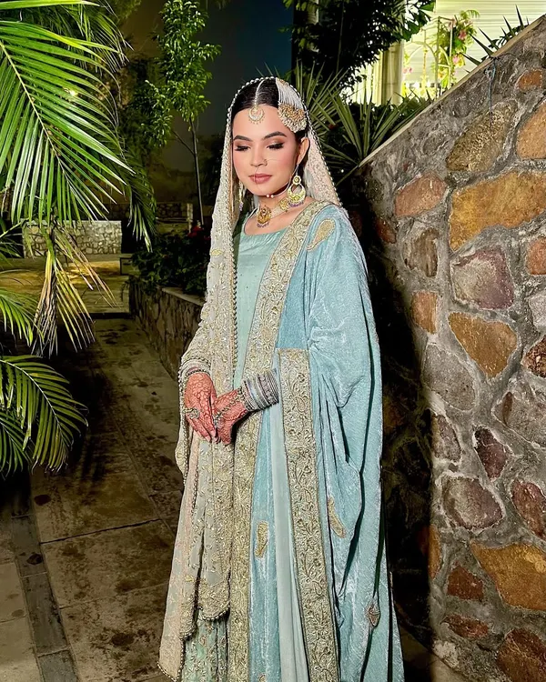 A full-length shot of my stunning Nikah bride. Her pastel blue and silver outfit is paired with soft, ethereal makeup, making her look like a true Shehzaadi.