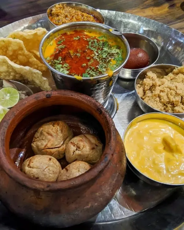 Food quality is my top priority, and this authentic Rajasthani thali shows my commitment to flavor. It features freshly made Dal Baati served in a traditional clay pot, Churma, zesty Kadhi, and other accompaniments for a complete regional meal.