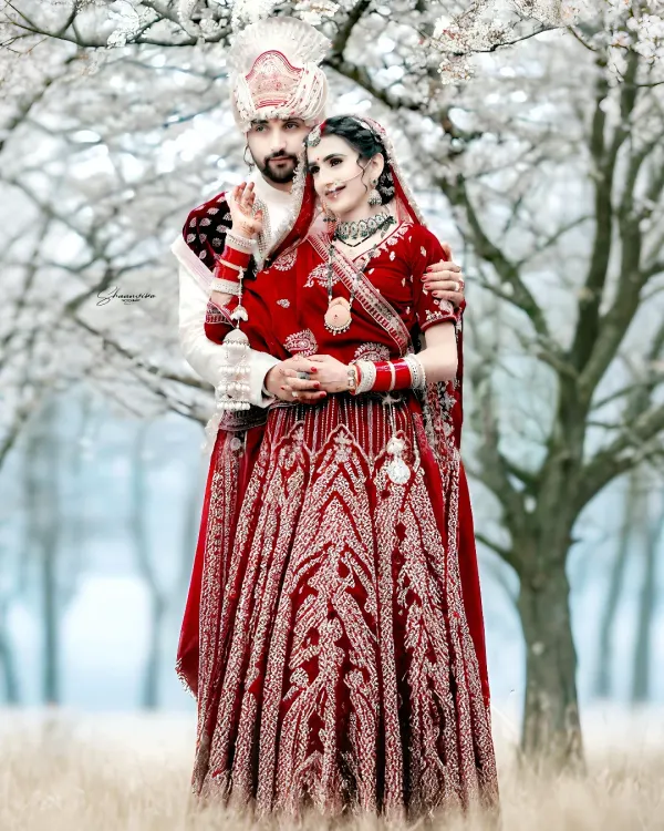 This is what it's all about. A classic wedding portrait where the couple's vibrant red attire stands out beautifully against the serene, almost magical backdrop. I aim to create timeless images like this for you.