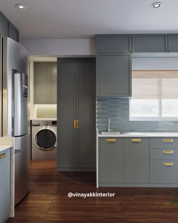 This view of the powder-blue kitchen shows how I seamlessly integrated a utility area. A discreet pocket door slides away to reveal the washing machine, keeping the main kitchen area looking clean and uncluttered.