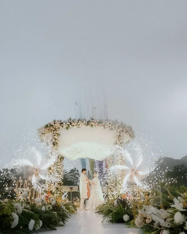 A breathtaking moment under a floral mandap, framed by celebratory fireworks. We believe your wedding day should feel like a movie, and we are here to capture the grand finale of your love story against the most stunning backdrops.