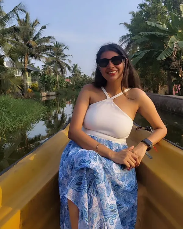 Exploring the serene backwaters of Alleppey. For a boat ride, I chose a comfortable and chic white halter top with a flowy blue printed skirt.