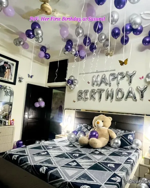 Her first birthday at her 'sasural' (in-laws' home) is a memory to cherish forever. This full room view shows the thoughtful decoration in purple and silver, designed to make her feel loved and celebrated in her new home.