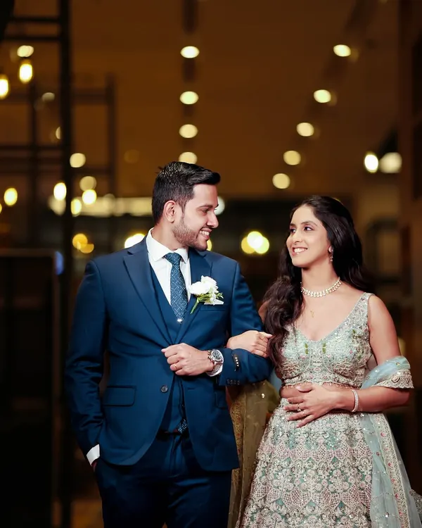 A beautiful moment between the couple. Her soft pink shimmer eye look and radiant base create a look of pure magic, perfect for their special day.